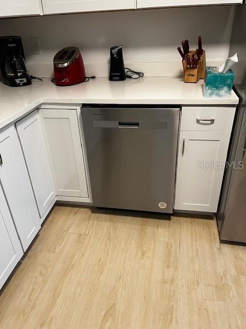 kitchen with light hardwood / wood-style floors, dishwasher, and white cabinets