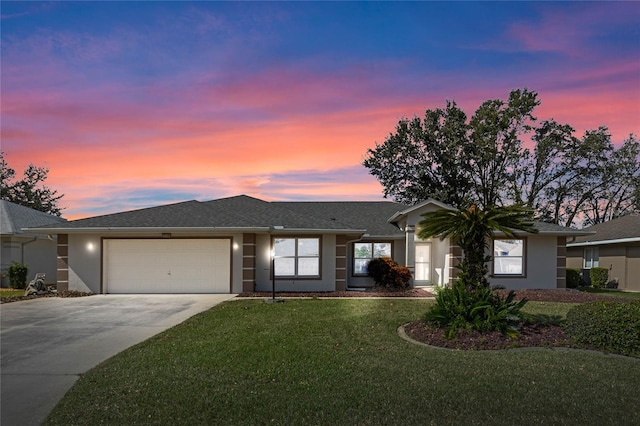 single story home featuring a yard and a garage