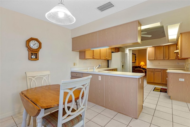 kitchen with exhaust hood, white fridge with ice dispenser, light tile patterned flooring, pendant lighting, and sink