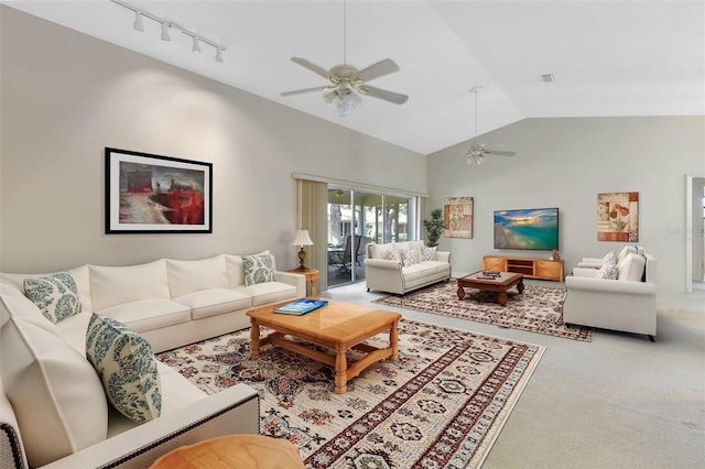 living room featuring high vaulted ceiling, carpet floors, rail lighting, and ceiling fan