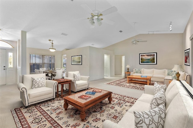 carpeted living room featuring ceiling fan and vaulted ceiling