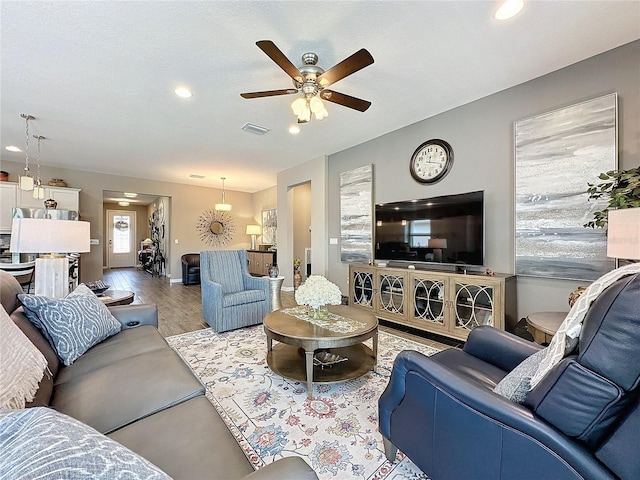 living room with light hardwood / wood-style floors and ceiling fan