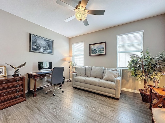 office space featuring ceiling fan and light wood-type flooring