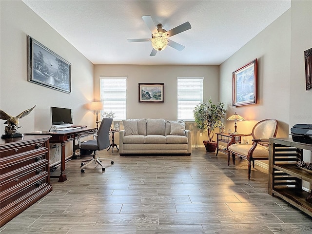 office area with a wealth of natural light, hardwood / wood-style flooring, and ceiling fan