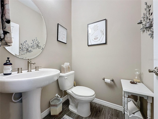 bathroom with toilet and wood-type flooring