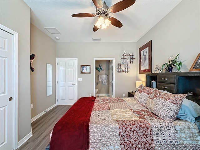 bedroom with ensuite bathroom, hardwood / wood-style flooring, a textured ceiling, and ceiling fan