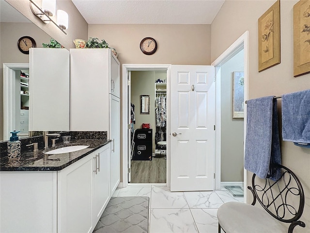 bathroom featuring vanity, hardwood / wood-style flooring, and a textured ceiling