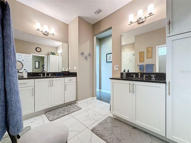 bathroom with vanity and a shower