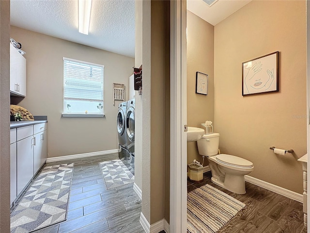 bathroom with vanity, washer and clothes dryer, wood-type flooring, and toilet