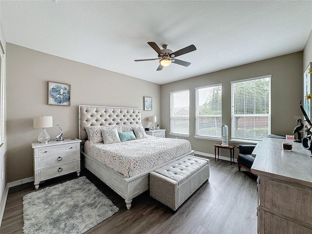 bedroom featuring a textured ceiling, ceiling fan, and dark hardwood / wood-style floors