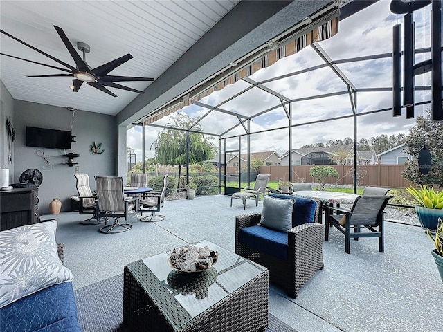 view of patio featuring glass enclosure and ceiling fan