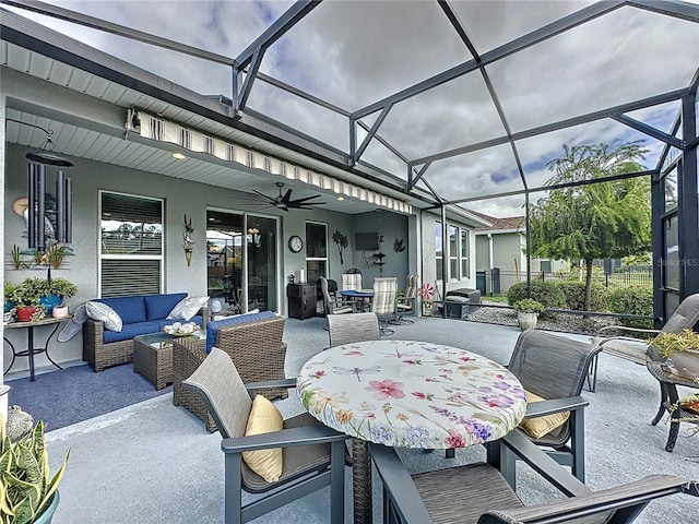 view of patio featuring a lanai, outdoor lounge area, and ceiling fan