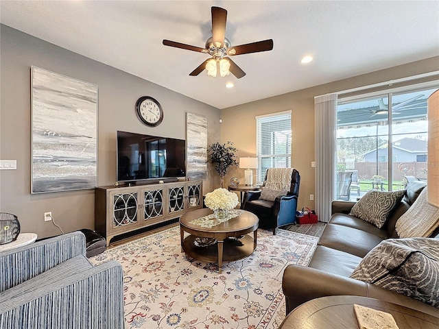 living room with light hardwood / wood-style flooring and ceiling fan