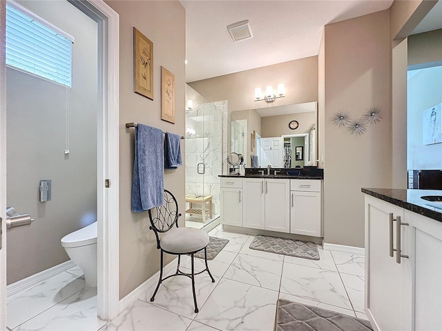 bathroom featuring an enclosed shower, vanity, toilet, and a textured ceiling