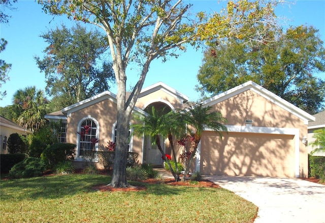 ranch-style home with a garage and a front lawn