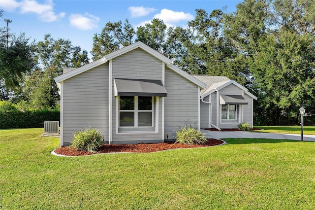 view of front of property with cooling unit and a front yard