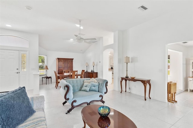 living room with high vaulted ceiling, light tile patterned floors, and ceiling fan