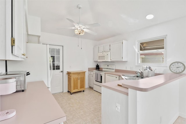 kitchen featuring kitchen peninsula, white cabinets, ceiling fan, sink, and white appliances