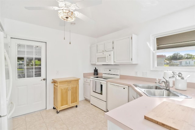 kitchen with white appliances, sink, ceiling fan, white cabinets, and light tile patterned floors