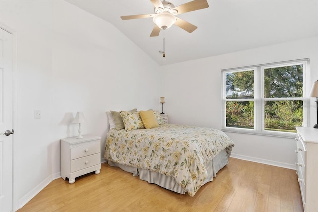 bedroom with hardwood / wood-style floors, vaulted ceiling, and ceiling fan