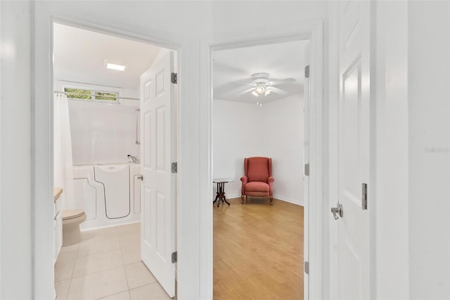 hallway with light hardwood / wood-style floors