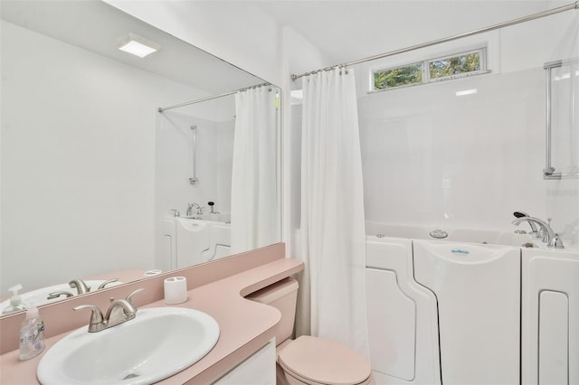 full bathroom with vanity, shower with separate bathtub, and toilet