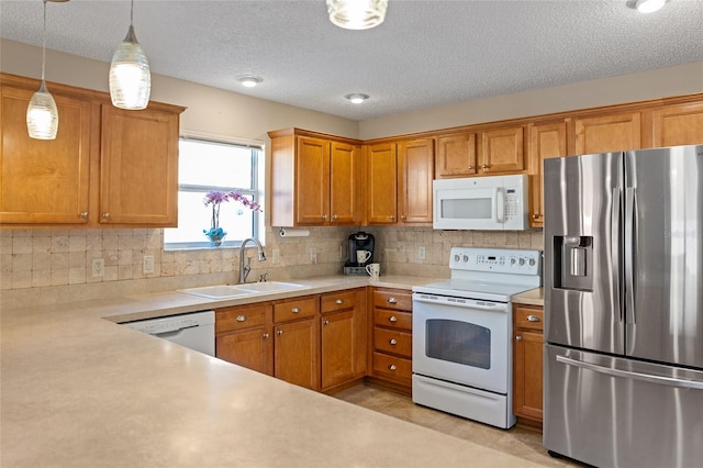 kitchen with white appliances, sink, backsplash, pendant lighting, and light tile patterned floors