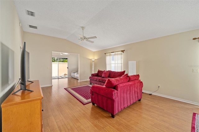 living room with light hardwood / wood-style flooring, lofted ceiling, plenty of natural light, and ceiling fan