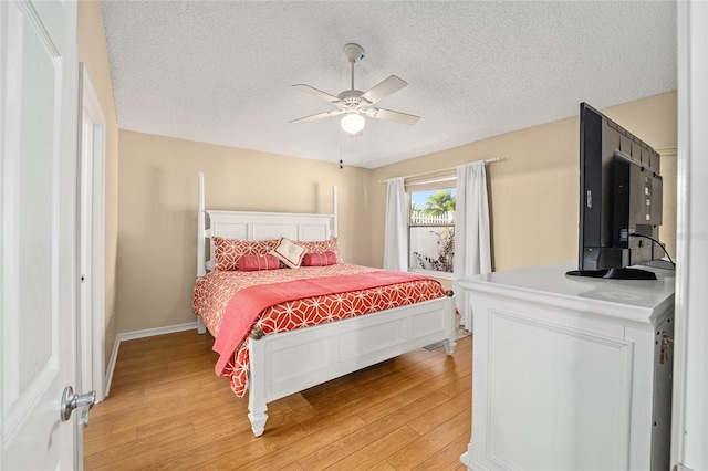 bedroom featuring a textured ceiling, hardwood / wood-style flooring, and ceiling fan