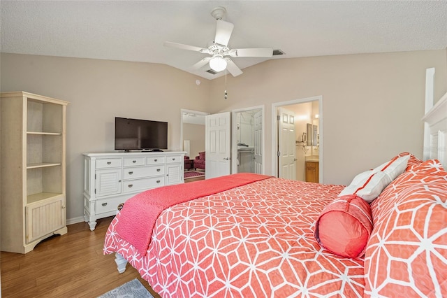 bedroom featuring ensuite bath, hardwood / wood-style flooring, vaulted ceiling, and ceiling fan