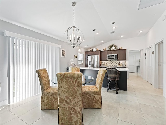 tiled dining area with lofted ceiling and a chandelier