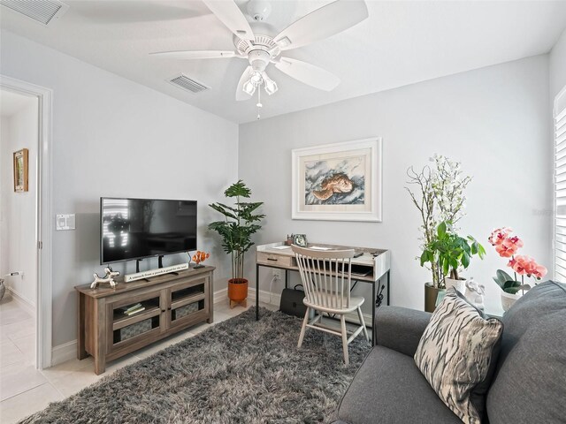 living room featuring ceiling fan and light tile patterned floors