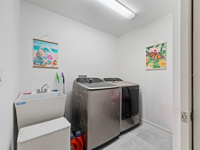 laundry area featuring sink and washer and clothes dryer