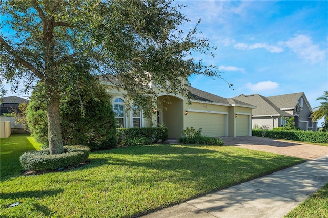 ranch-style house featuring a front yard and a garage