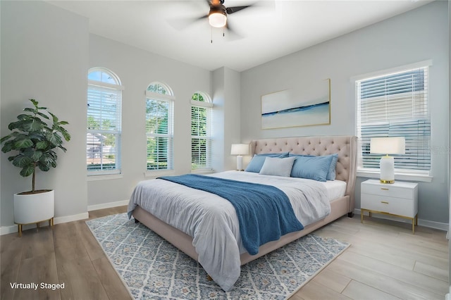 bedroom with light hardwood / wood-style floors and ceiling fan