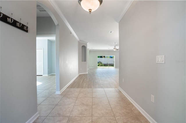 hall featuring ornamental molding and light tile patterned flooring