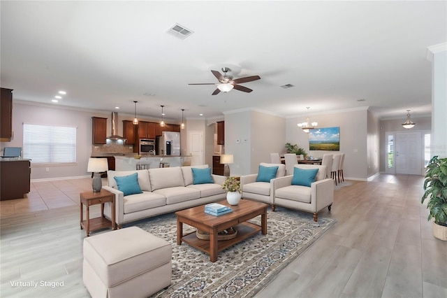 living room with crown molding, light hardwood / wood-style flooring, and ceiling fan with notable chandelier