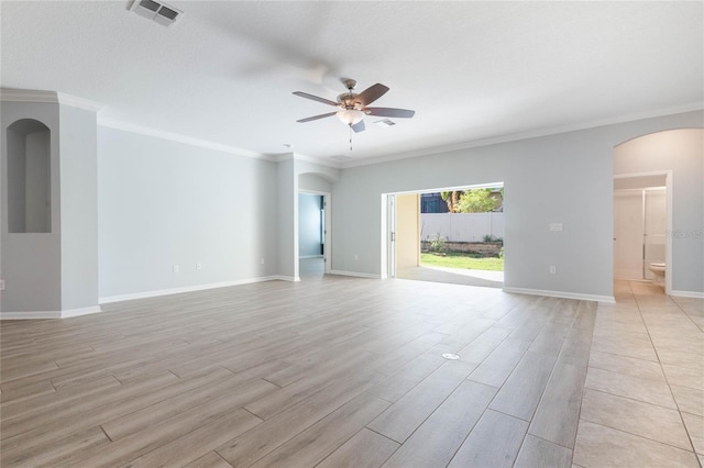 empty room featuring light hardwood / wood-style flooring, ornamental molding, and ceiling fan