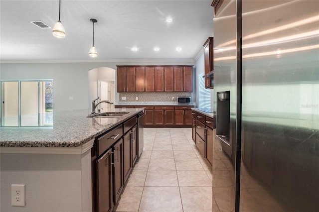 kitchen with decorative backsplash, sink, light stone countertops, crown molding, and appliances with stainless steel finishes