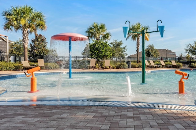 view of swimming pool with pool water feature