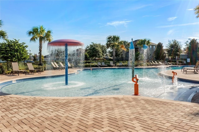 view of pool with pool water feature and a patio area