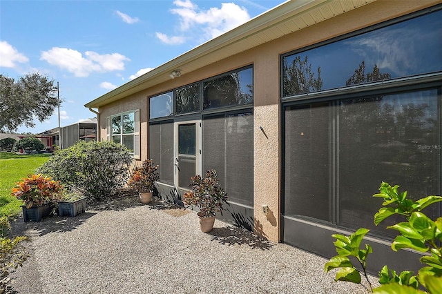 view of property exterior with a patio area