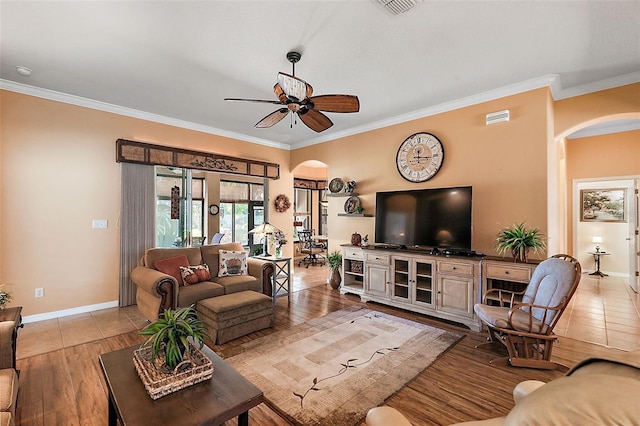 living room with ornamental molding, light hardwood / wood-style flooring, and ceiling fan