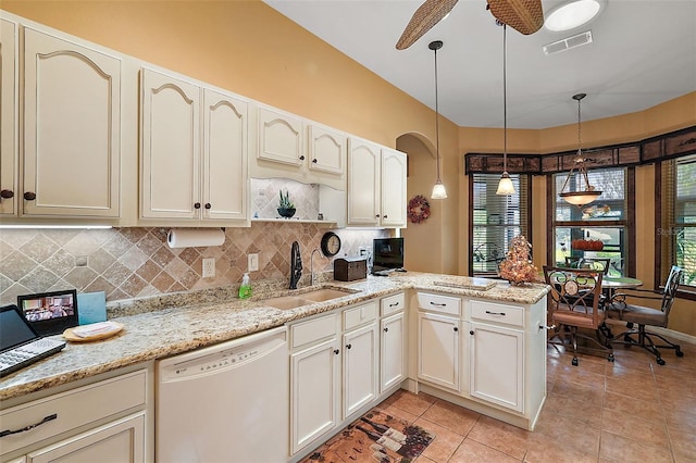 kitchen with sink, dishwasher, pendant lighting, and plenty of natural light