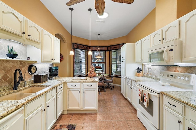 kitchen featuring white appliances, sink, kitchen peninsula, pendant lighting, and light tile patterned floors