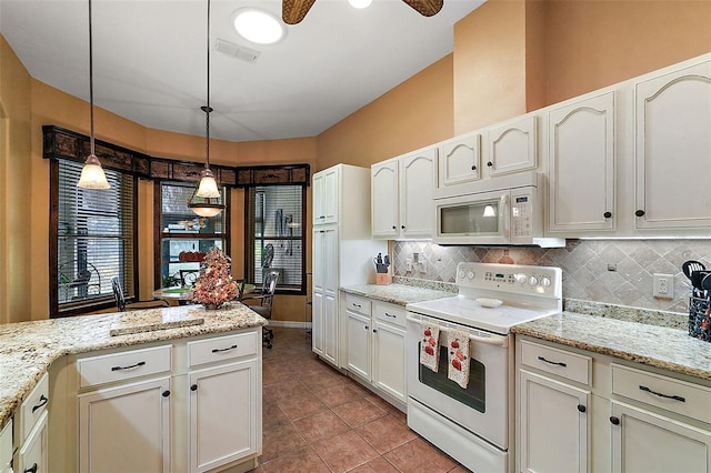 kitchen with hanging light fixtures, ceiling fan, light stone countertops, light tile patterned flooring, and white appliances