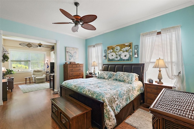 bedroom featuring ornamental molding, light hardwood / wood-style floors, and ceiling fan