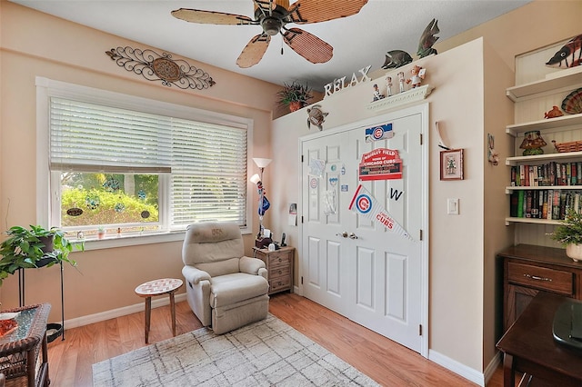 sitting room featuring ceiling fan and light wood-type flooring