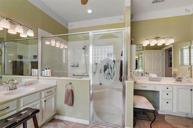 bathroom with vanity, an enclosed shower, and ceiling fan