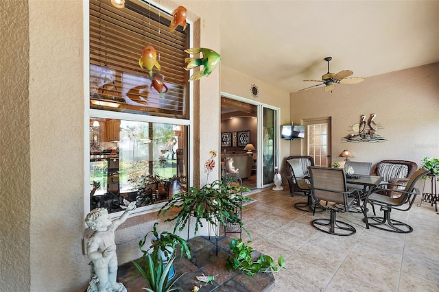 interior space with ceiling fan